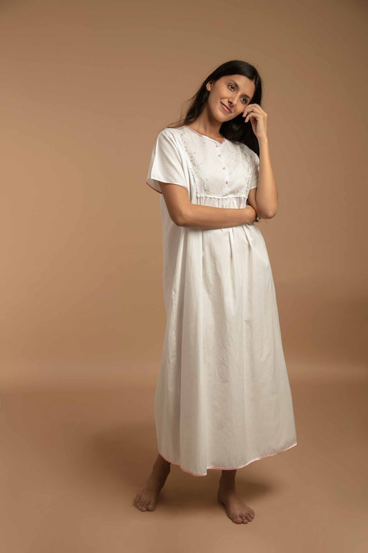 Elegant white nightdress with floral embroidery, perfect for comfortable sleep.