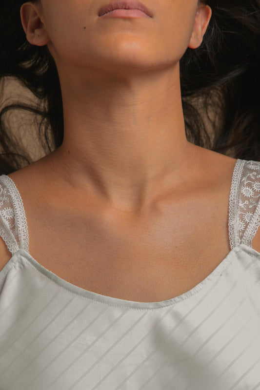 Woman wearing the Tara shorts set with delicate lace straps.