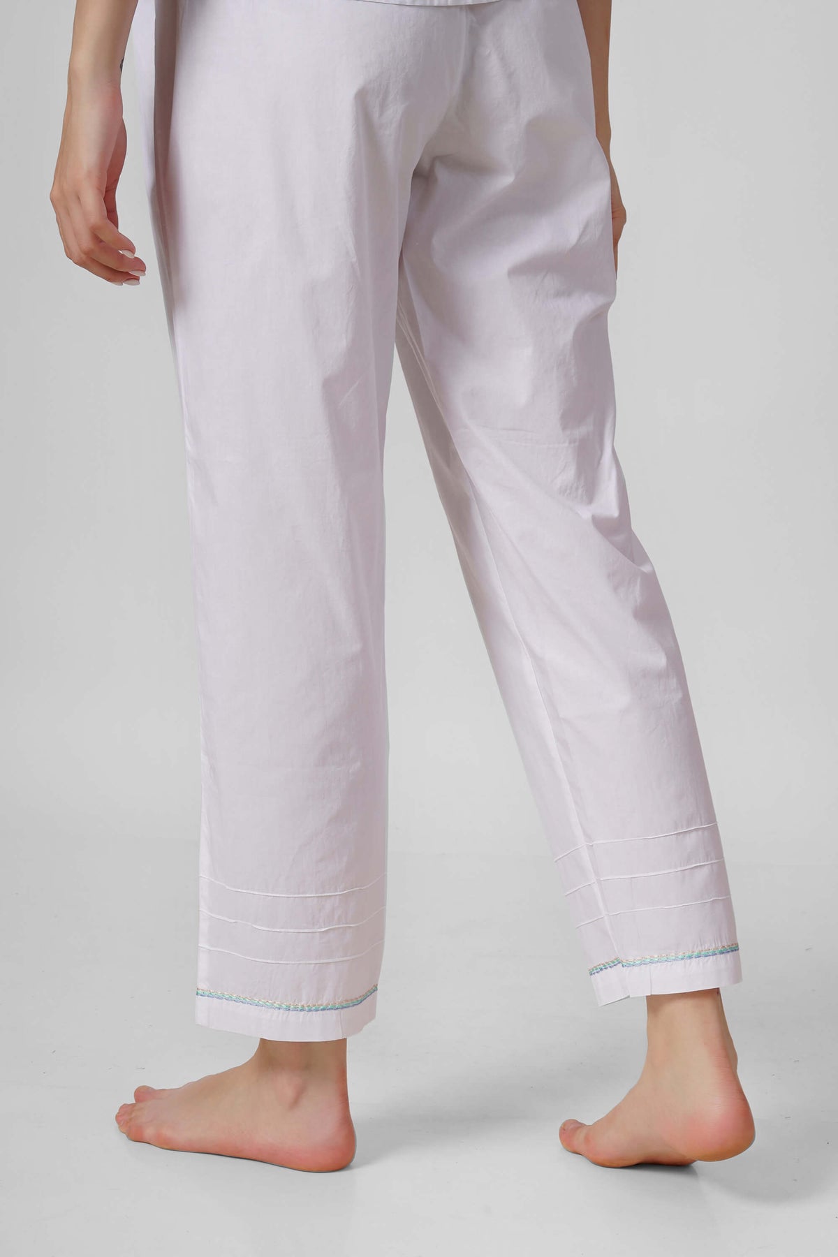 Nora Pyjama Suit featuring stylish white pants with embroidered hem.