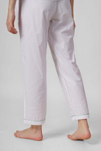 Nora Pyjama Suit featuring stylish white pants with embroidered hem.