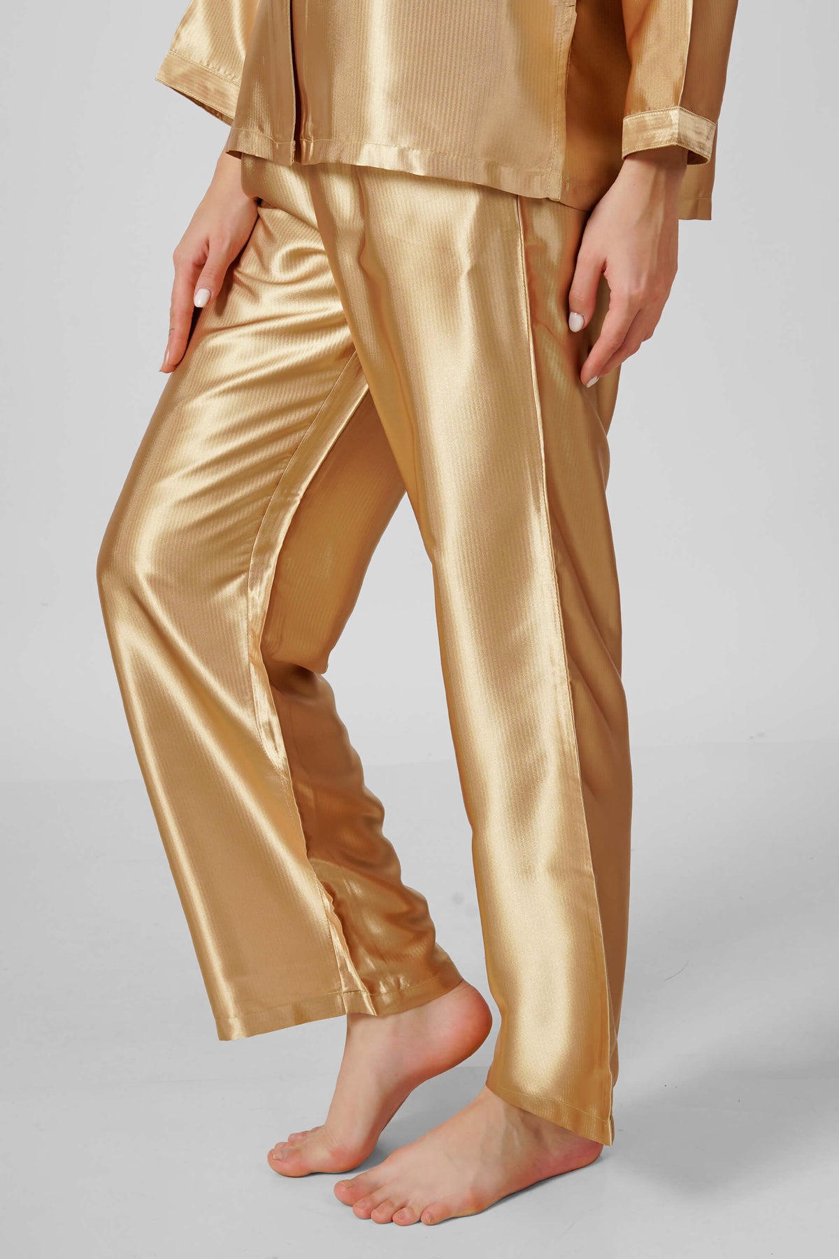 Eden-G golden pyjama suit featuring luxurious satin fabric and elegant design.