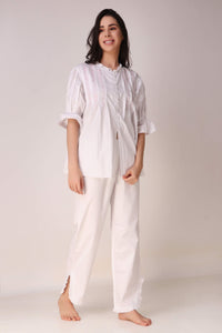 Elegant white pyjama suit for comfortable lounging and sleep.