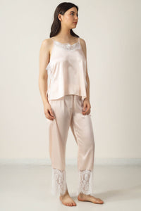 Elegant Tina pyjama suit in soft pink satin with lace details.