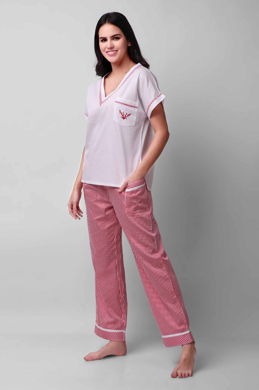 Woman wearing Candycane themed pajama set with red stripes.