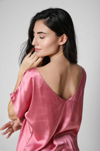 Model wearing Roxxy pink satin net shorts and top.