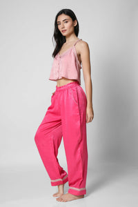 Stylish pink women's loungewear set featuring cropped top and pants.
