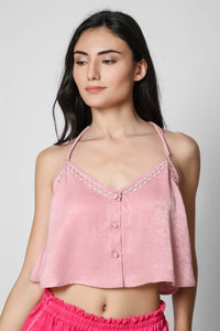 Pink sleeveless top with decorative buttons and embroidery design.