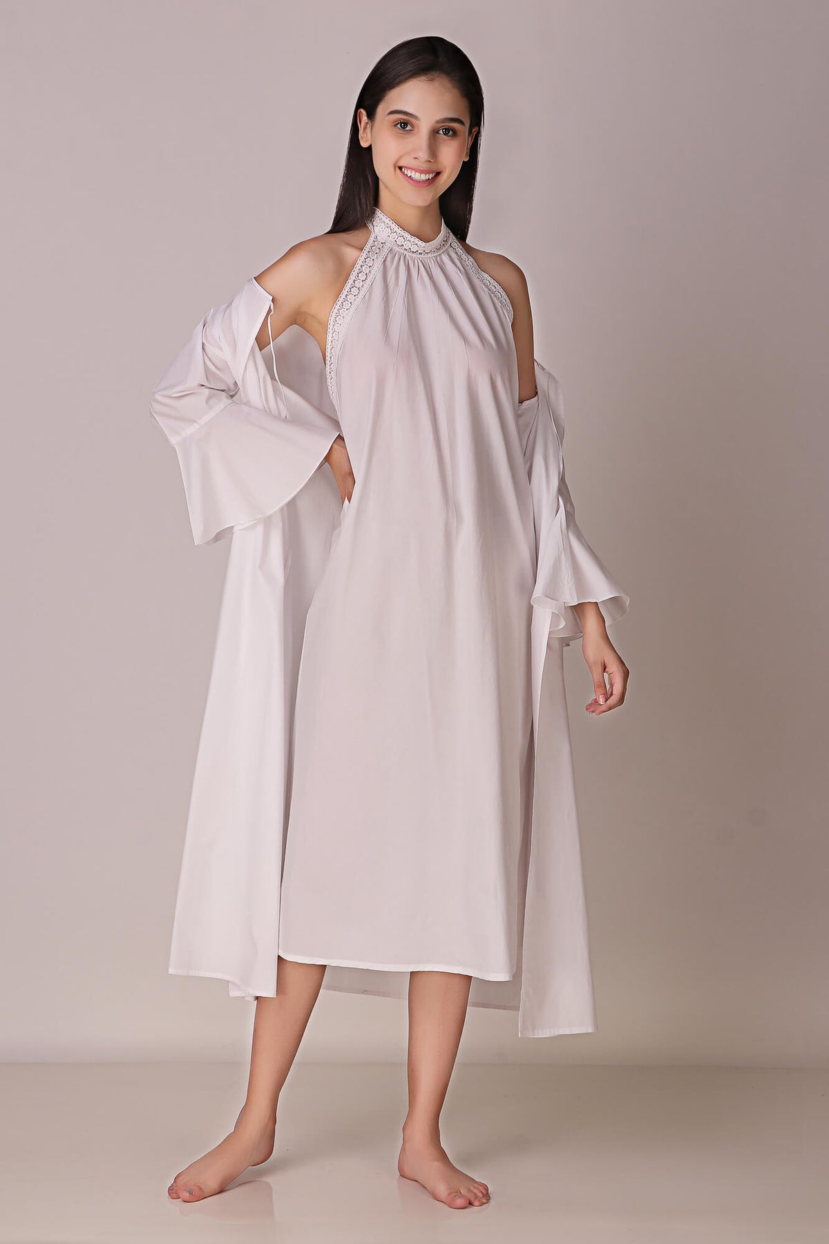 Elegant model wearing white Talisa backless dress and gown.
