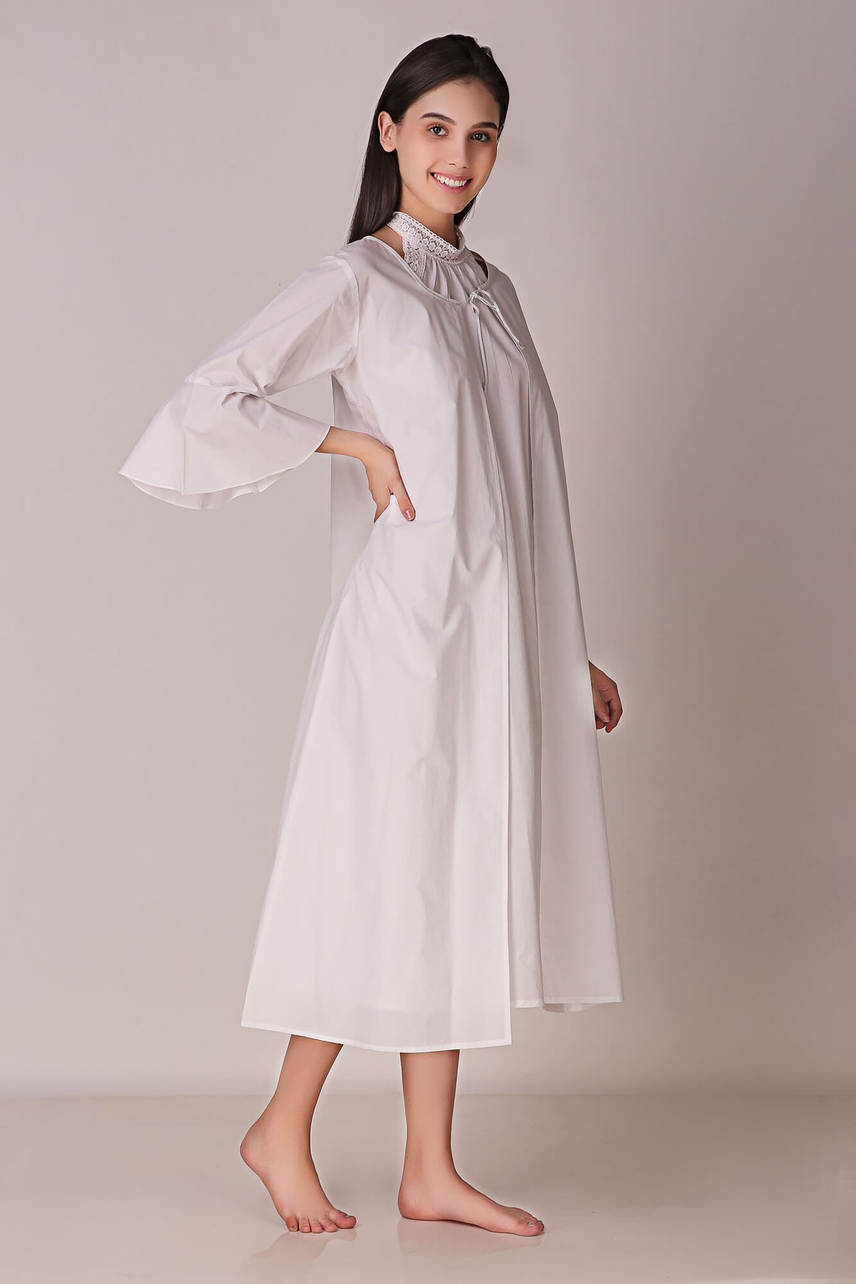 Elegant backless dress and gown in white fabric.