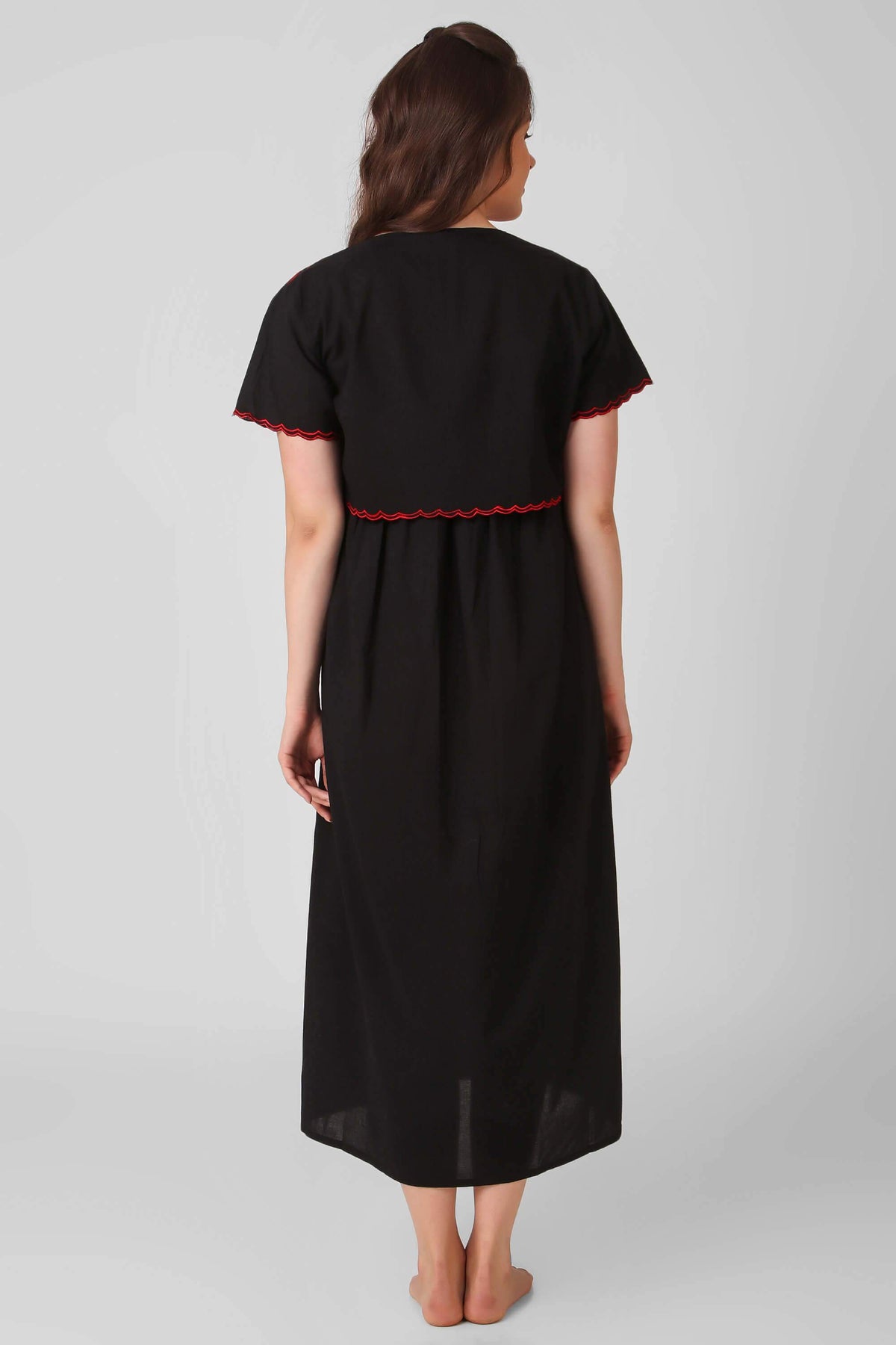 Black bolero dress and shrug with red detailing, back view.