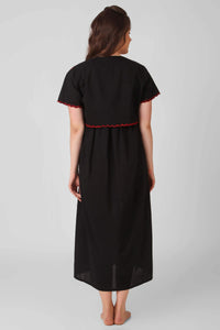 Black bolero dress and shrug with red detailing, back view.