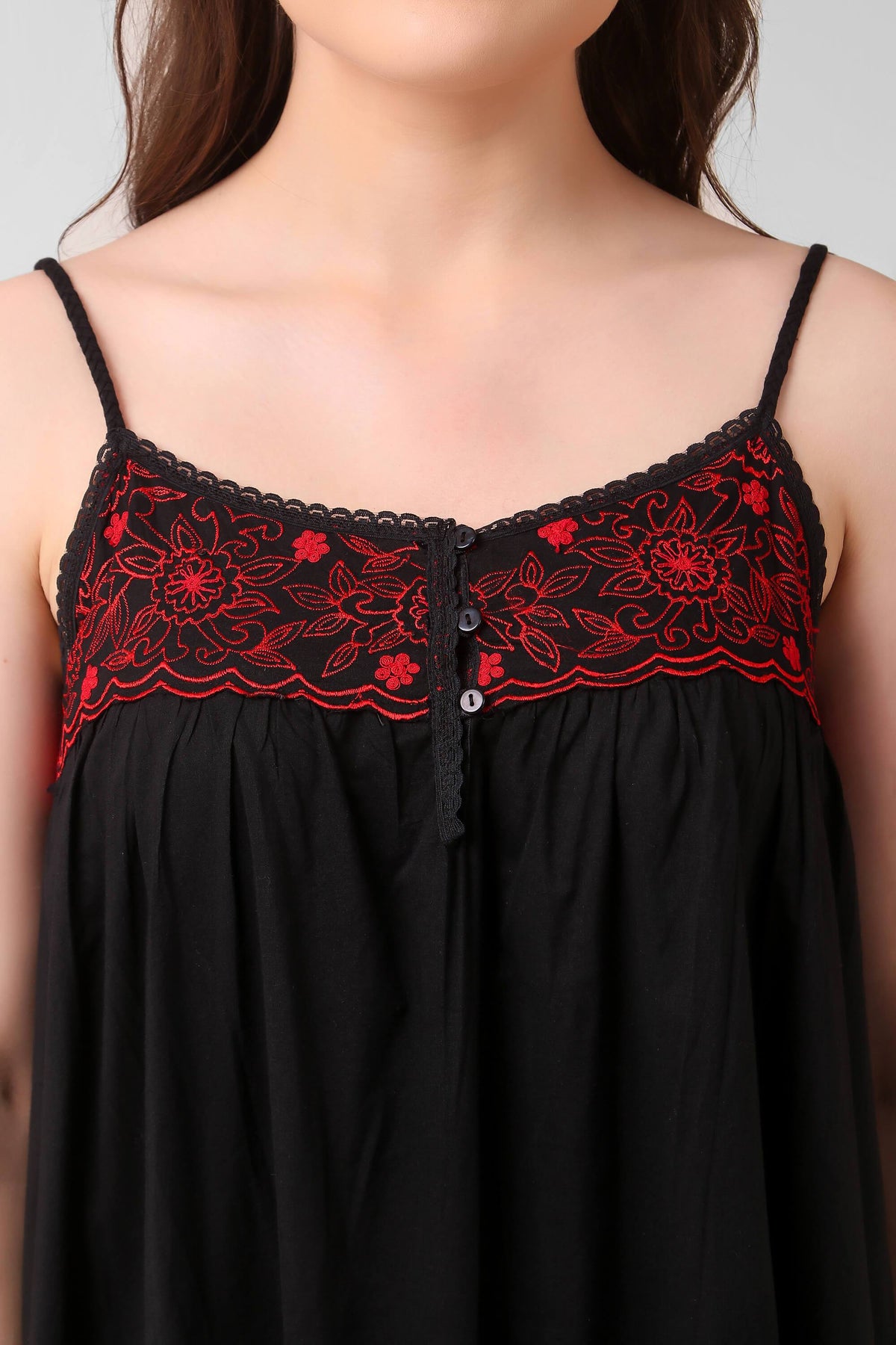 Black dress with red floral embroidery detail and button closure.