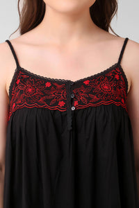 Black dress with red floral embroidery detail and button closure.
