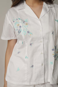 Women's white top with floral embroidery, part of the Aviv set.