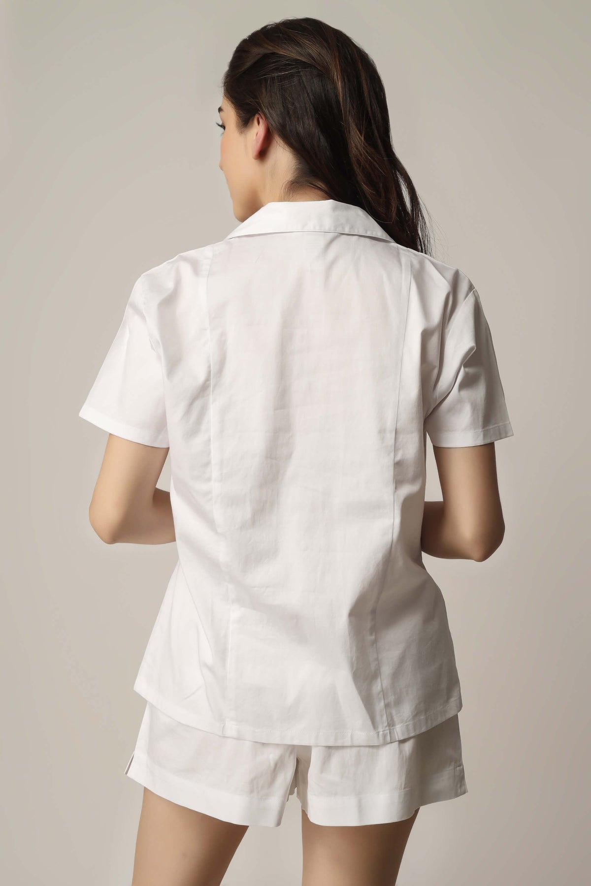 Model wearing white Aviv top and shorts set.