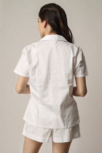 Model wearing white Aviv top and shorts set.