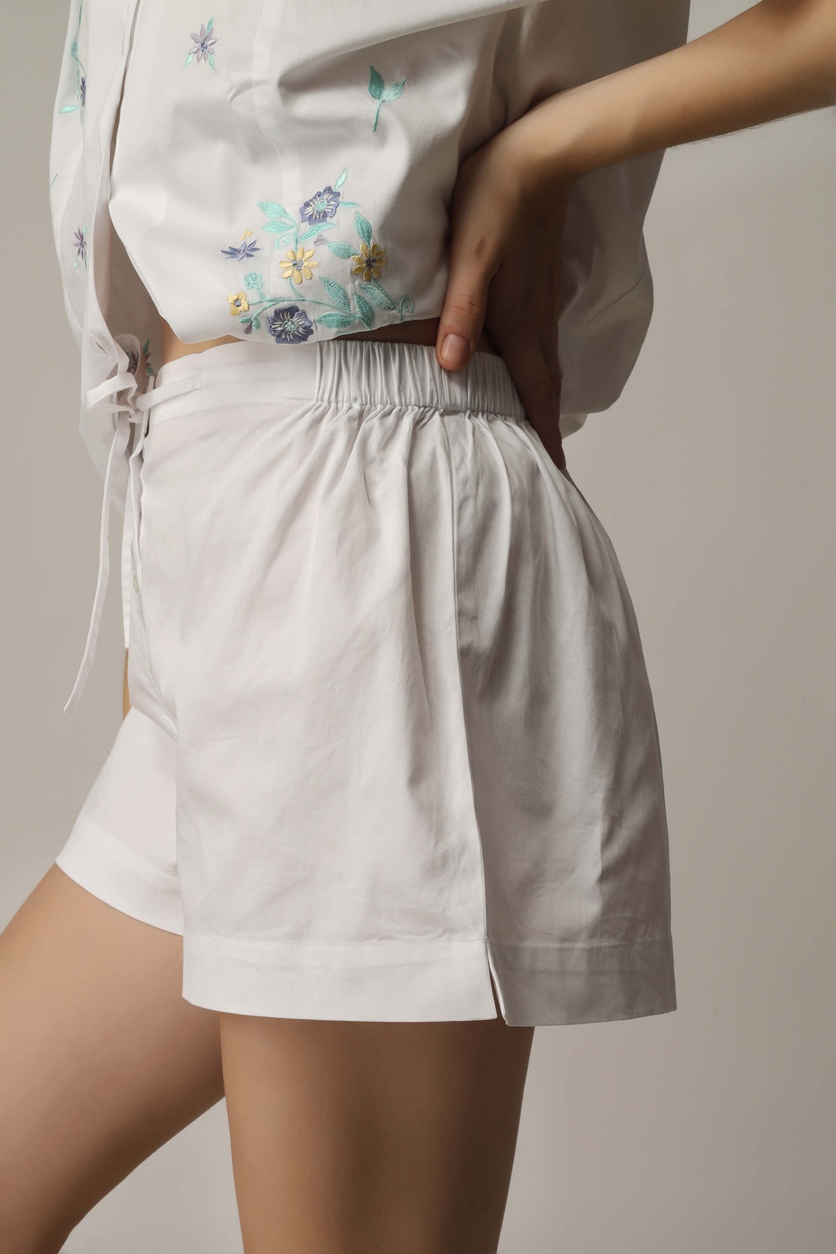 Stylish white shorts and floral top set for women.