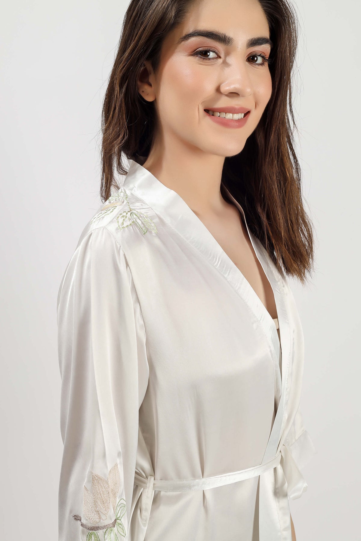 Elegant woman wearing Gen embroidered gown in soft fabric.