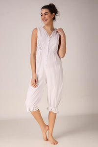 Elegant white Enola romper with lace details and buttons.