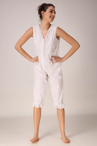 White Enola romper with intricate lace detailing and capri length.