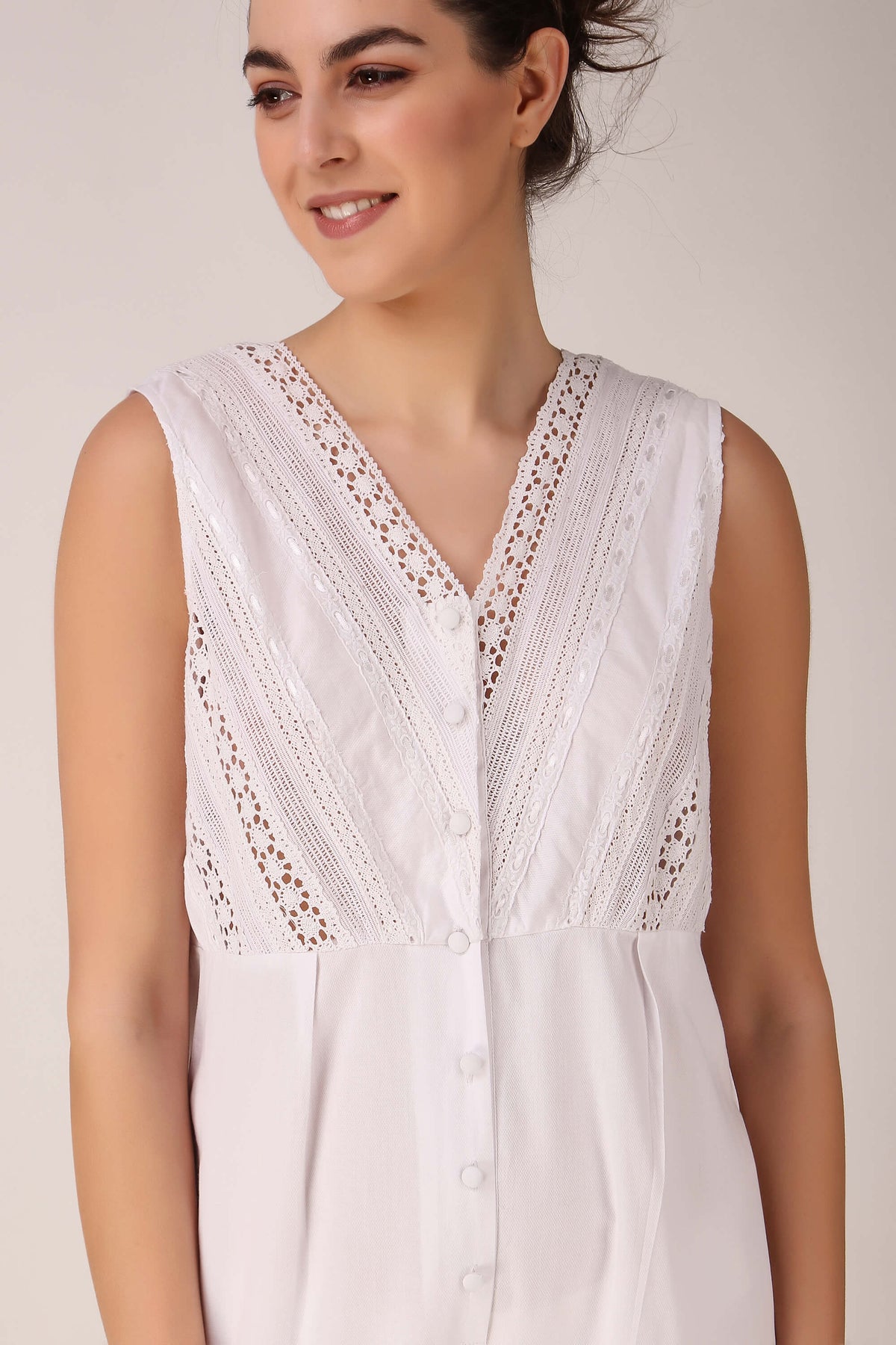 White lace-trimmed Enola romper with button details for stylish comfort.