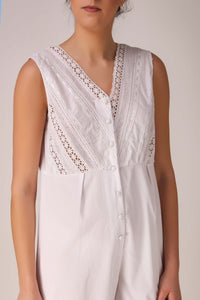 Elegant white Enola romper with lace detailing and button front.