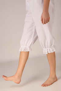 White Enola romper featuring embroidered lace cuffs and relaxed fit.