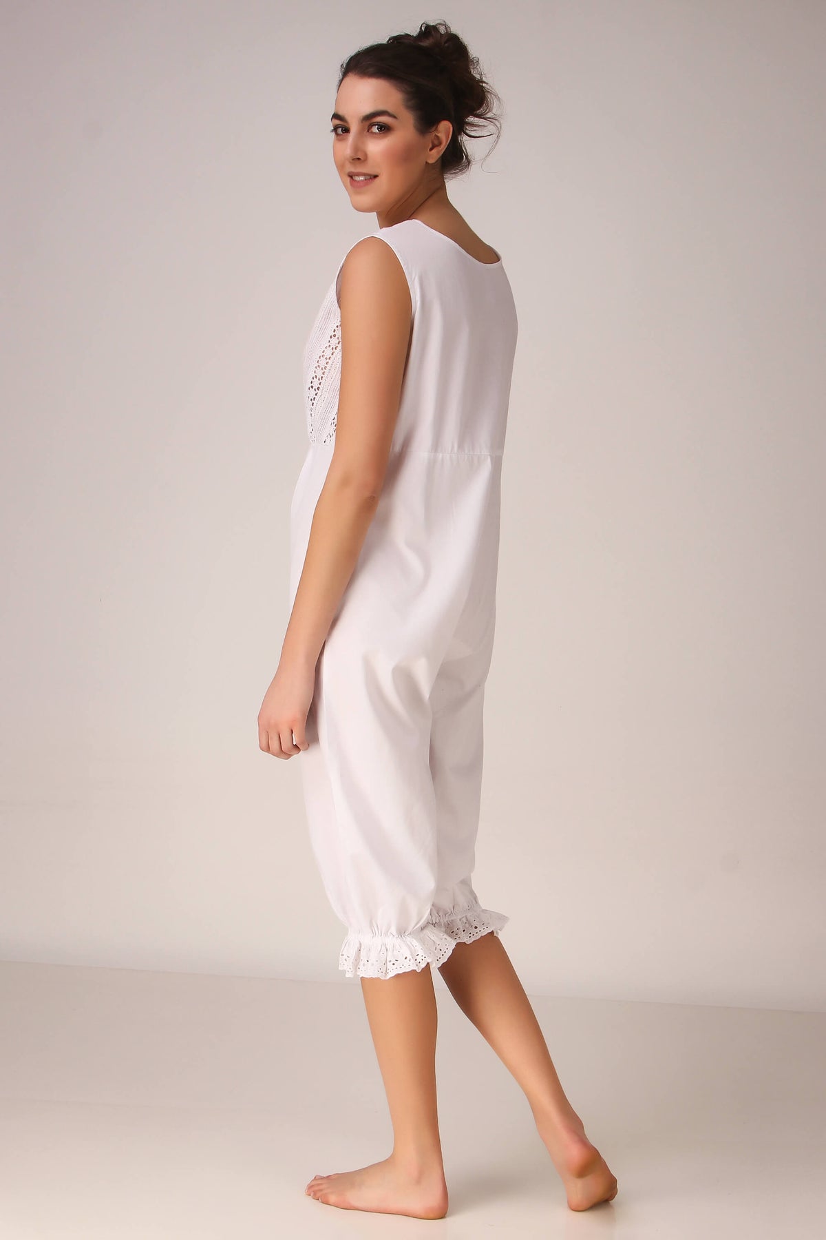 White Enola romper featuring lace detailing and a relaxed fit.