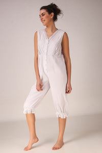 Stylish white Enola romper with lace detailing and button closure.