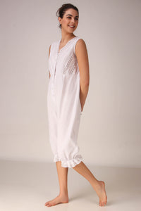 Elegant white Enola romper with lace detailing, perfect for summer.