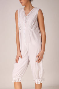 Stylish white Enola romper with lace detailing and button front.