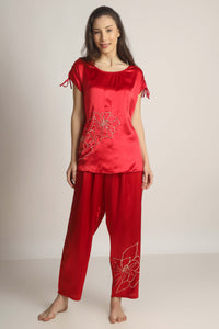 Elegant red satin pyjama suit with floral design for relaxing evenings.