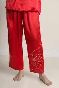 Red satin pyjama suit with floral embroidery details.