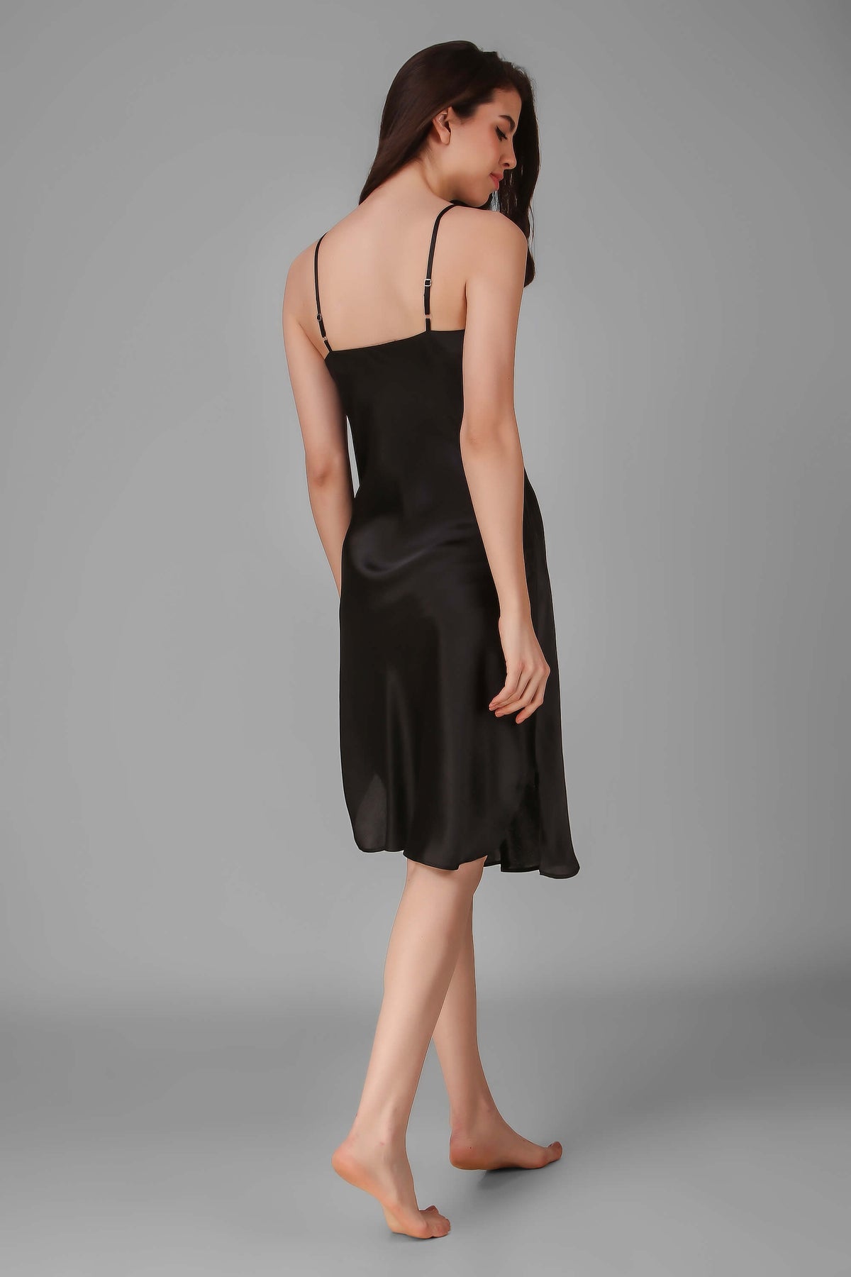 Elegant black satin Andromeda dress, showcasing back design and silhouette.