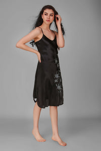 Elegant black Andromeda dress with floral embroidery, perfect for any occasion.