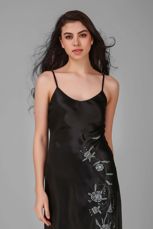 Elegant black Andromeda dress with floral embroidery and adjustable straps.