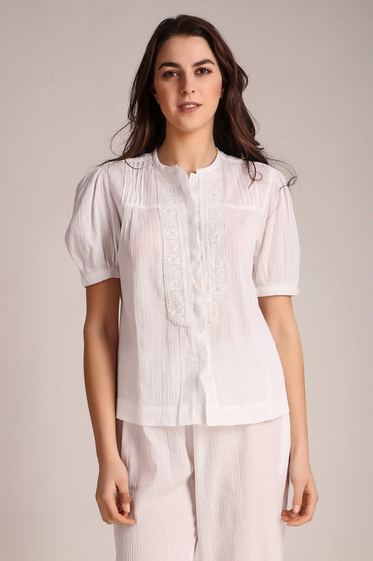 Elegant white Cecilia pyjama suit with puff sleeves and delicate detailing.