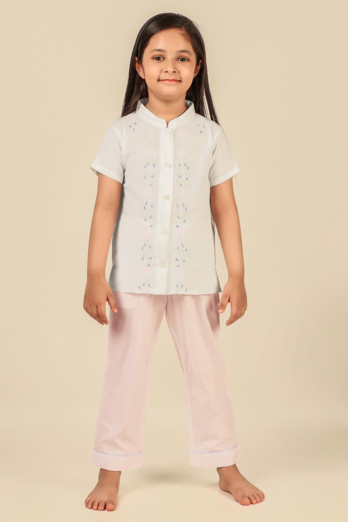 Girls' pyjama suit featuring floral design, perfect for comfortable sleepwear.