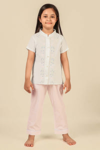 Girls' pyjama suit featuring floral design, perfect for comfortable sleepwear.