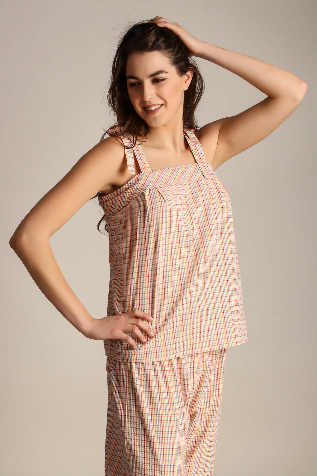 "Model showcasing Haylee Pyjama Suit in colorful plaid design."