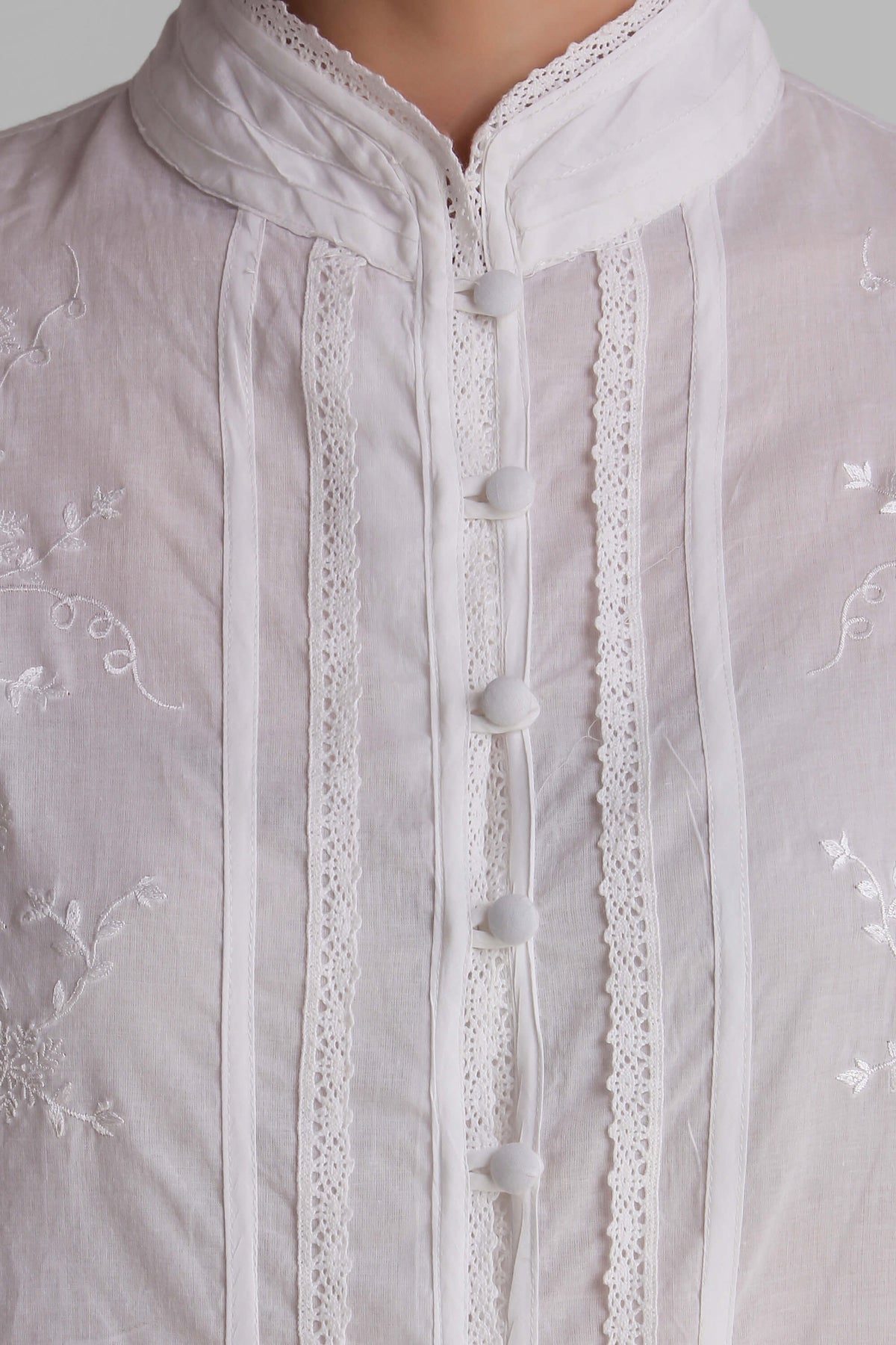 Elegant white embroidered pyjama suit with detailed button closure.