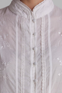 Elegant white embroidered pyjama suit with detailed button closure.