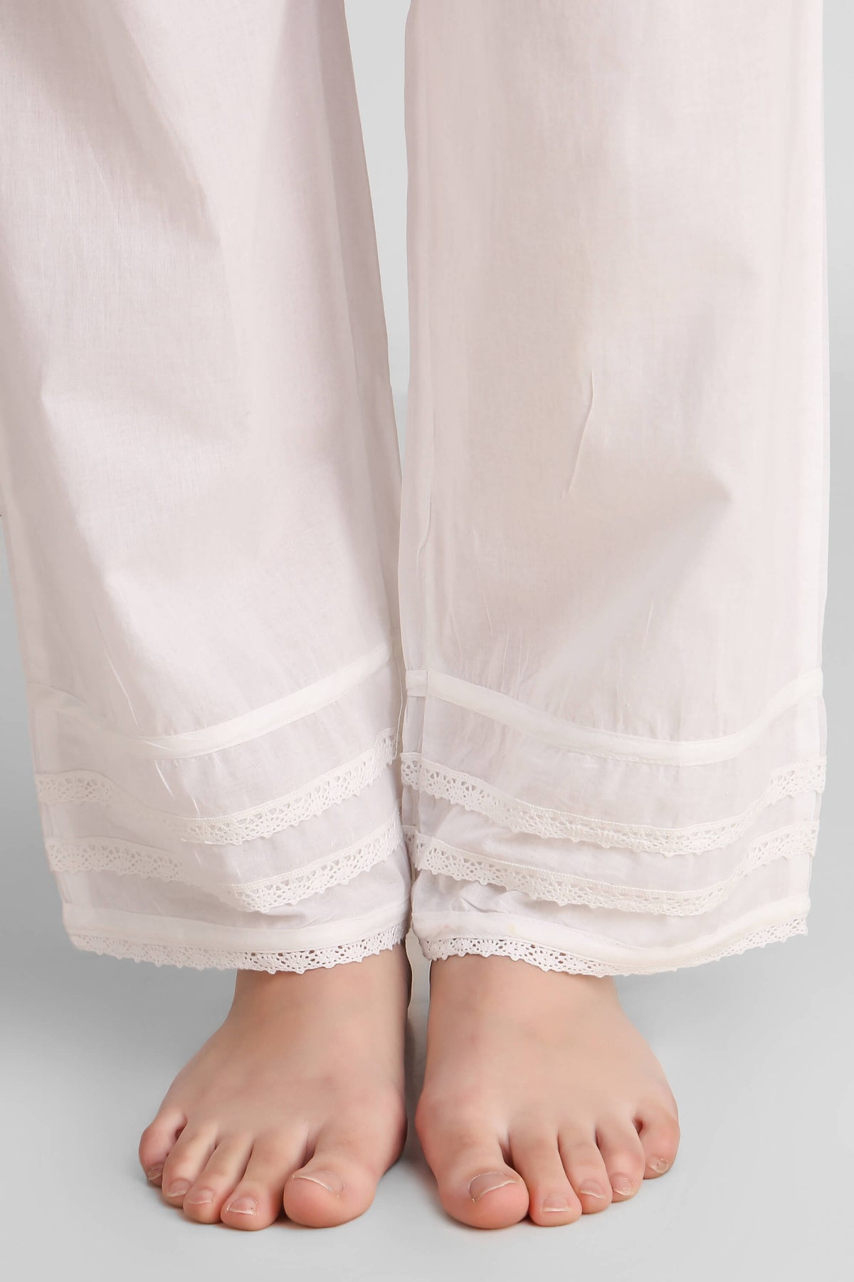 Elegant white pyjama suit with lace trim details.