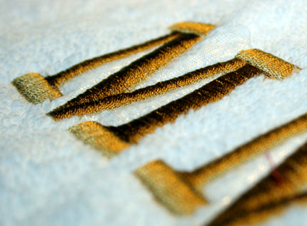 Close-up of custom embroidery design on fabric.