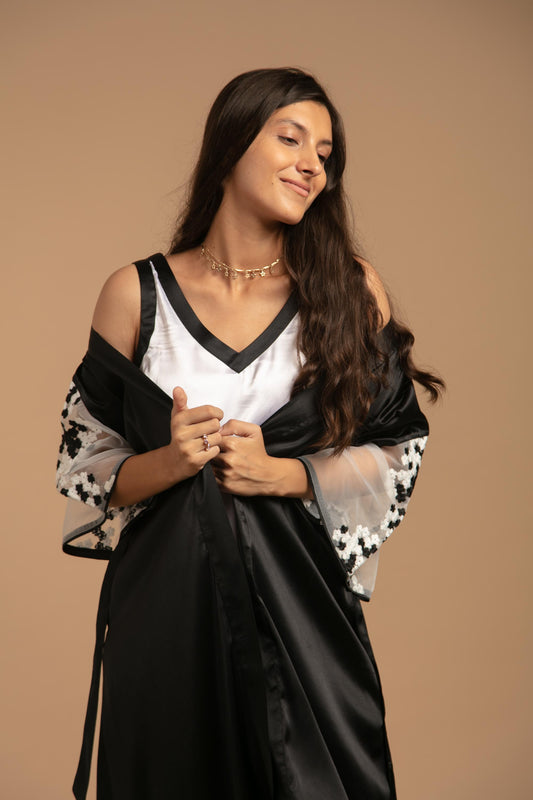 Elegant woman modeling Denise nightdress and gown with floral details.