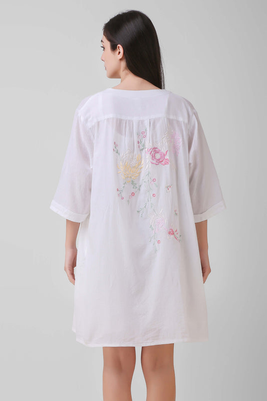 White embroidered dress with floral design, perfect for casual wear.