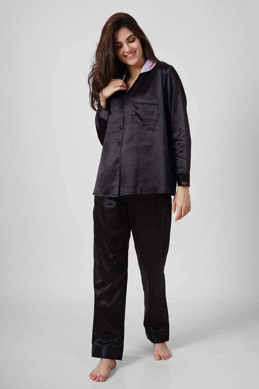 Elegant black satin pyjama suit for stylish comfort at home.