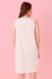 Back view of Jia nightdress on a model against a pink background.