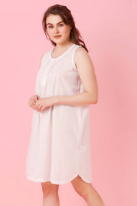 Jia Nightdress model posing in soft pink background.