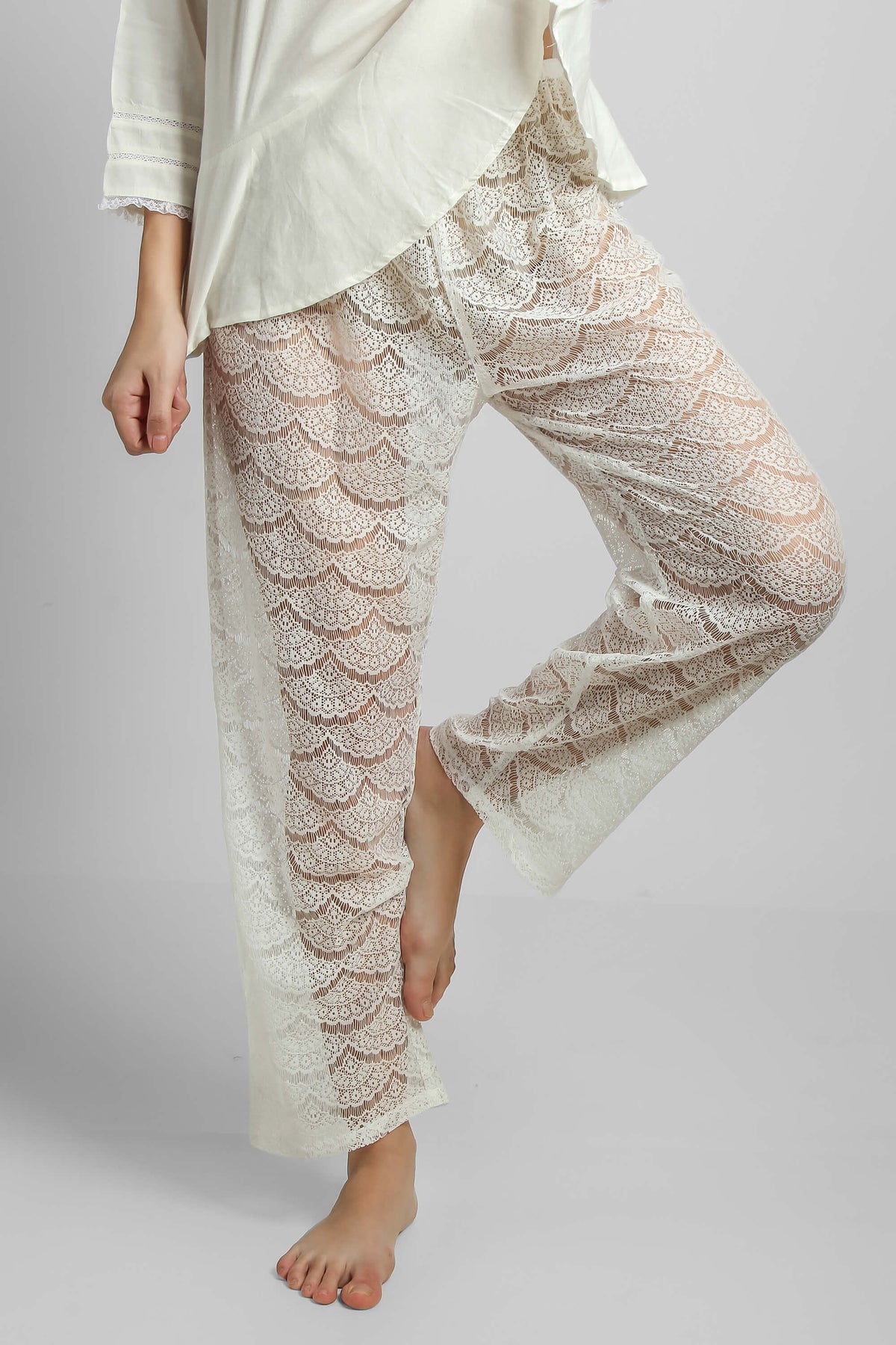 Lace pyjama suit featuring stylish shorts and elegant top.